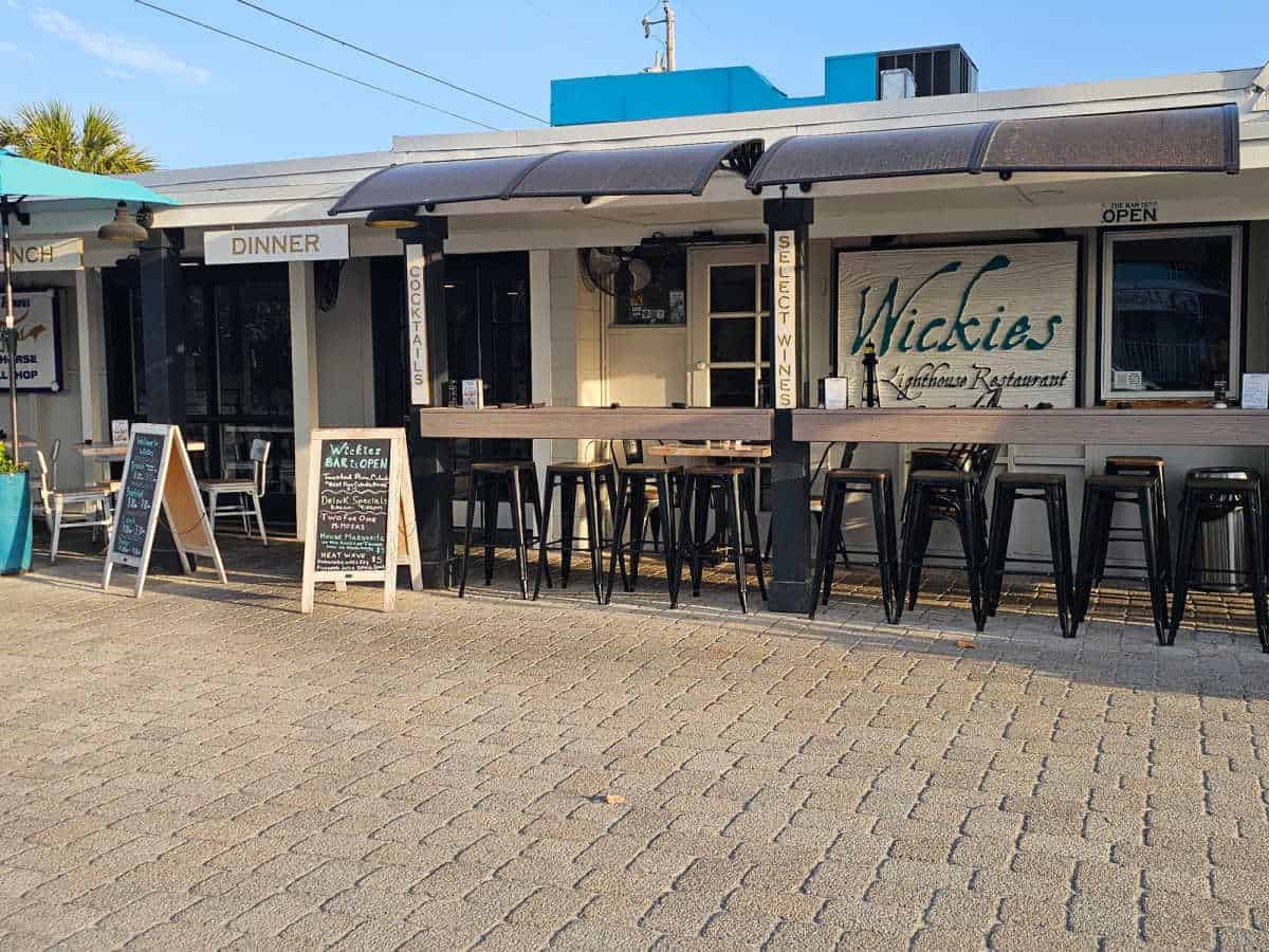 Restaurant exterior with Wickies lighthouse restaurant sign and outdoor seating