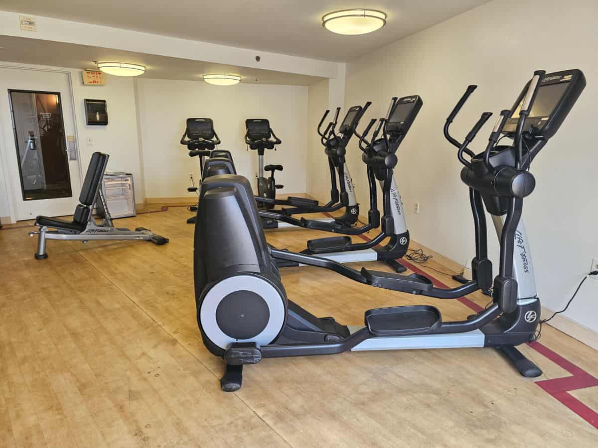 fitness center with elipticals and weight bench
