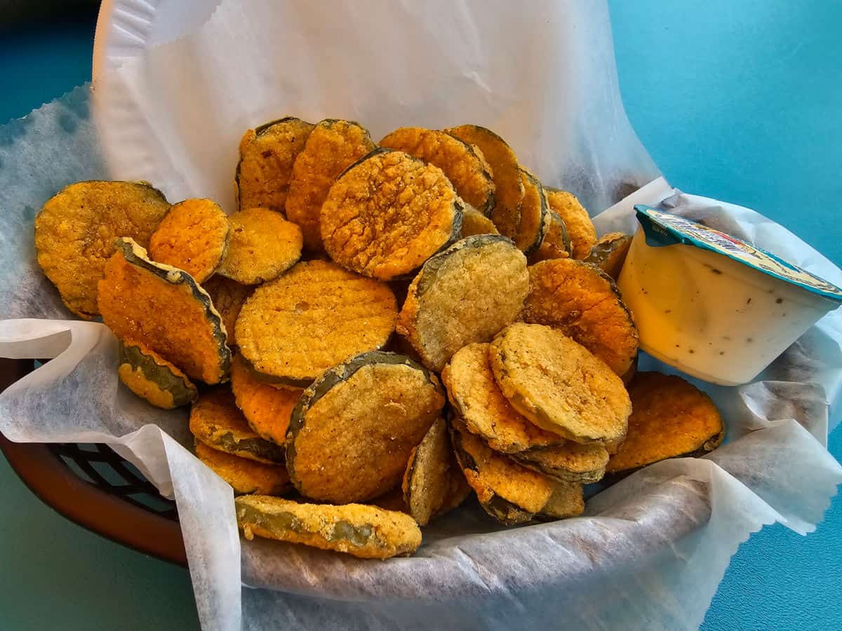 fried pickles and ranch in a paper lined basket