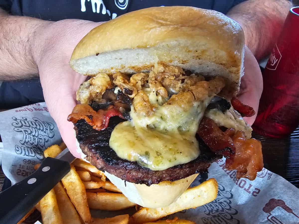 hand holding a giant burger