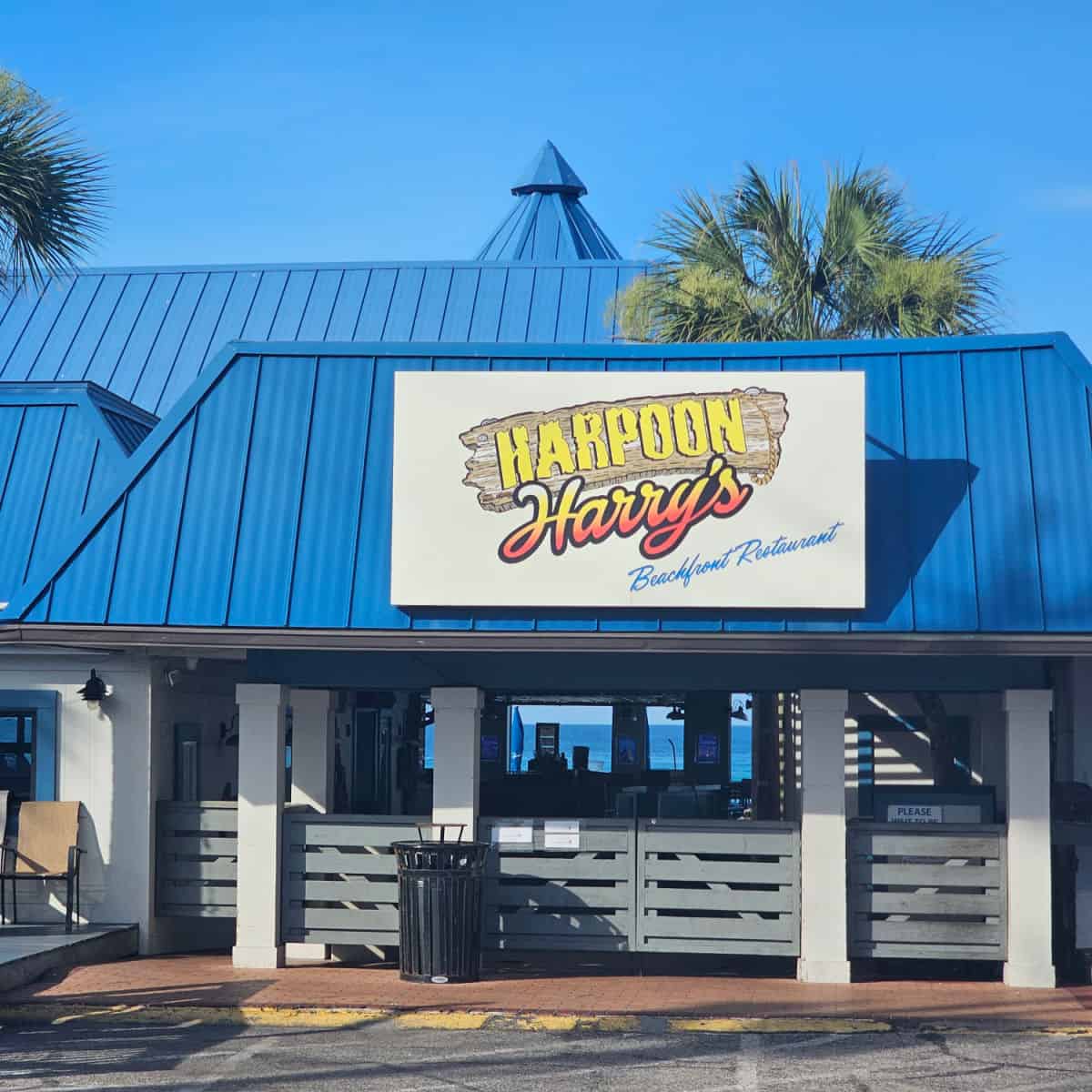 Harpoon Harrys sign on a blue awning over the restaurant looking out to the Gulf