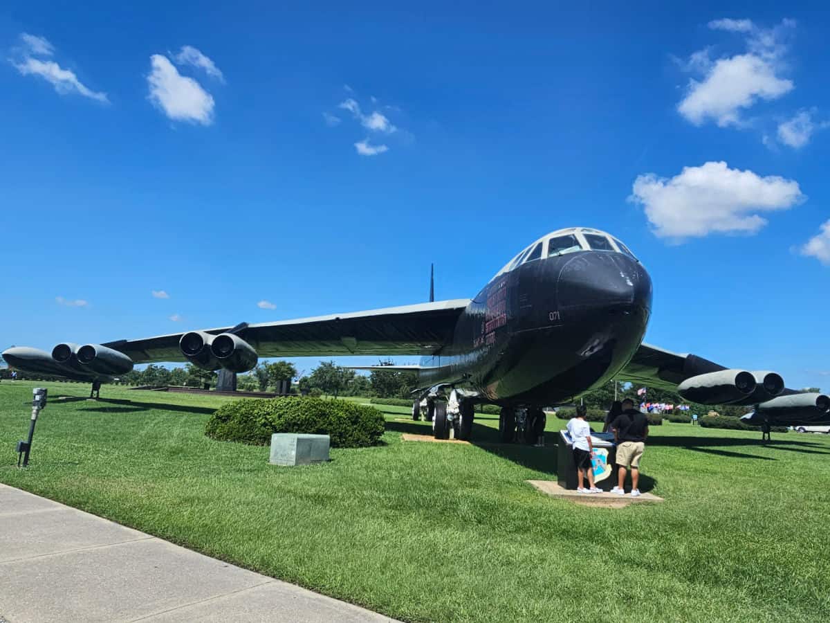 large airplane with family standing under it