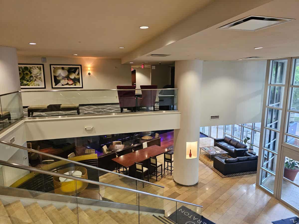 two story lobby with stairs leading down to the main entrance
