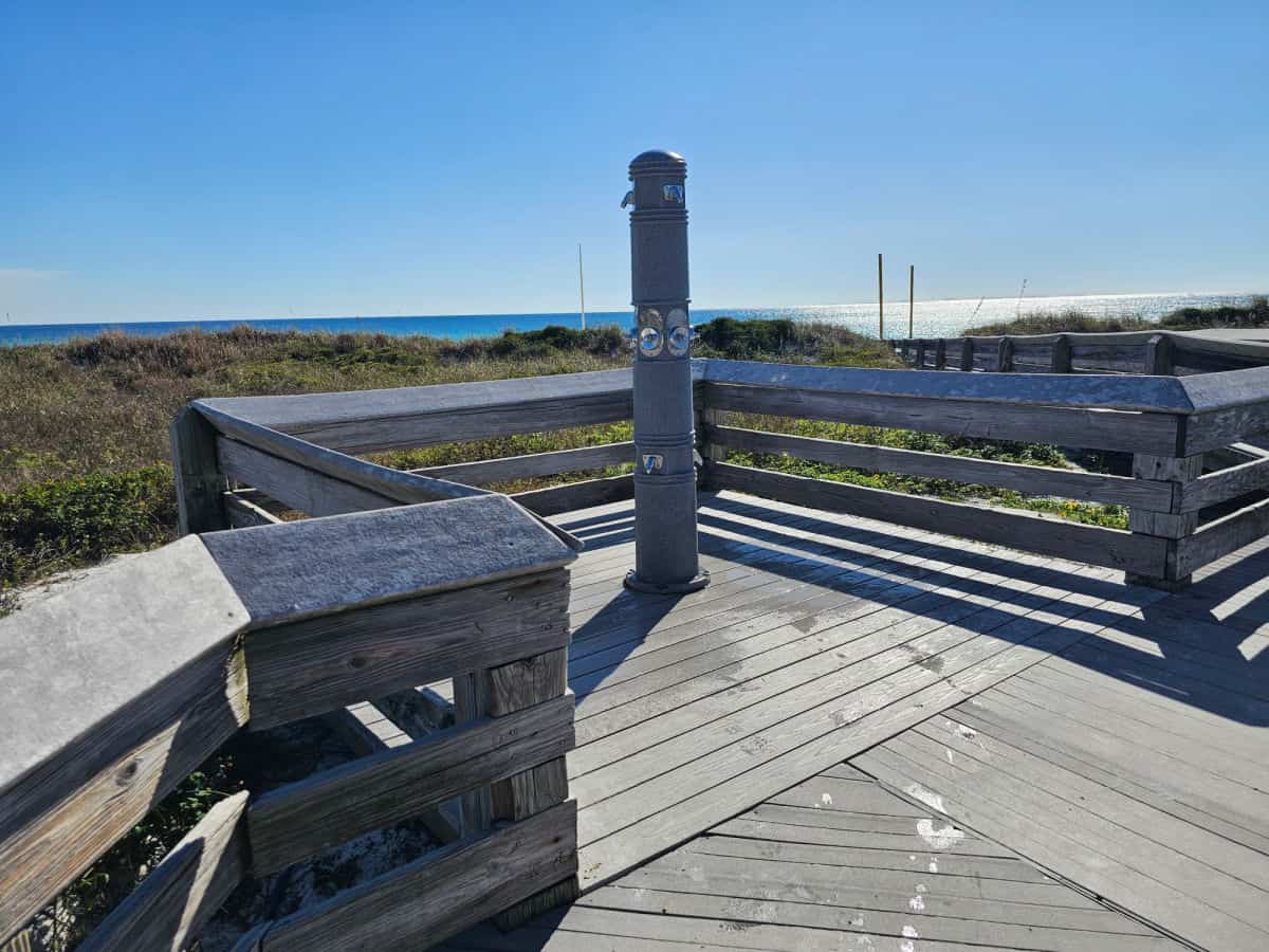outdoor shower on boardwalk with the Gulf in the distances