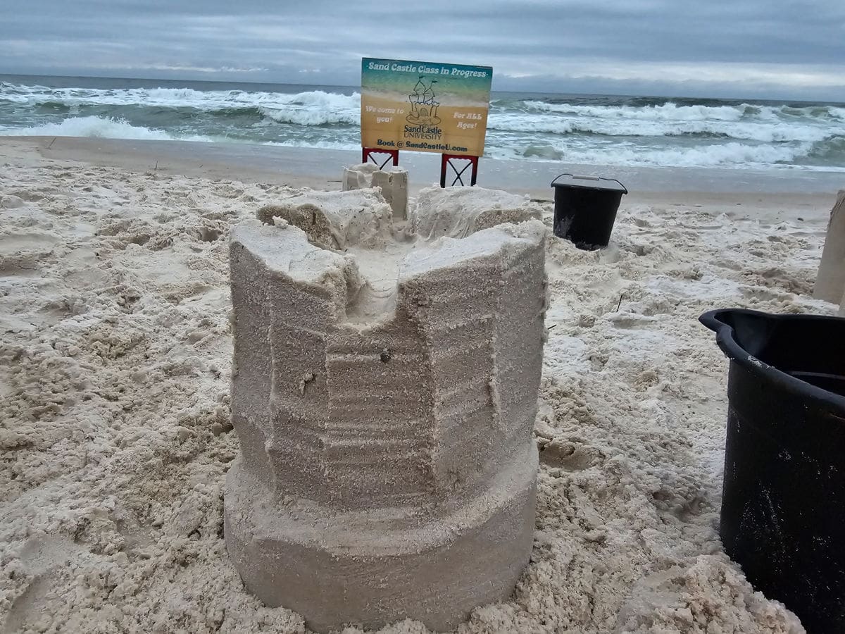 sand castle next to the Gulf with a sign