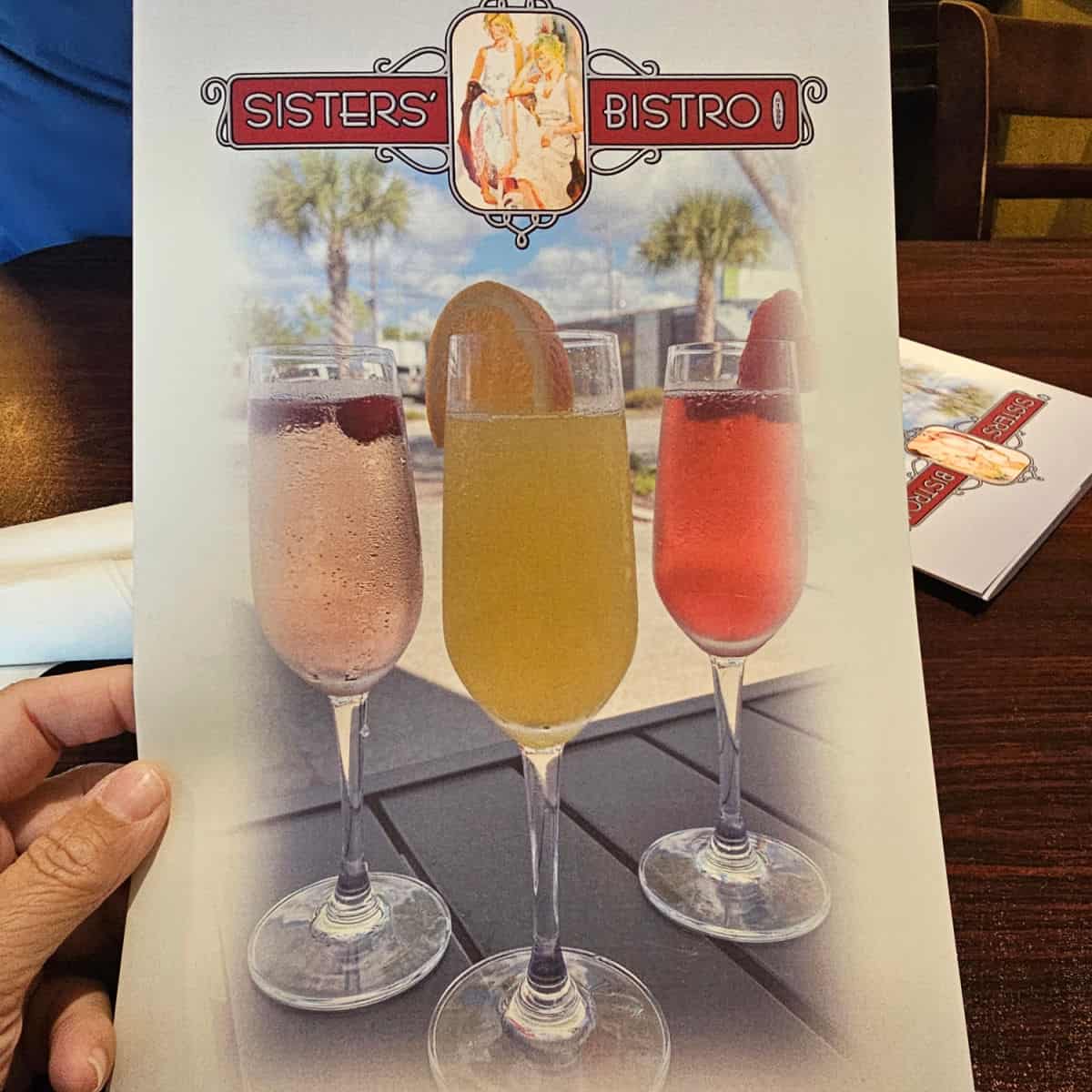 sisters Bistro Port St Joe menu cover with three mimosas