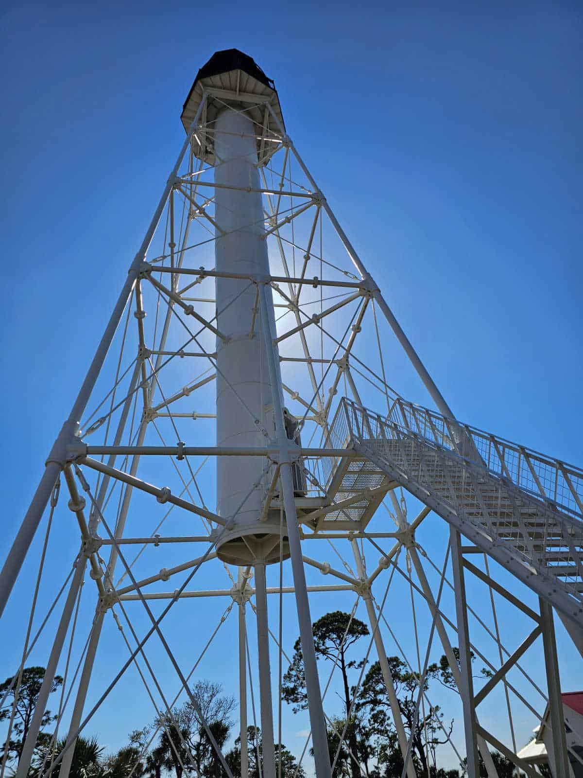 Looking up at the Cape san blas lighthouse with the sun behind it
