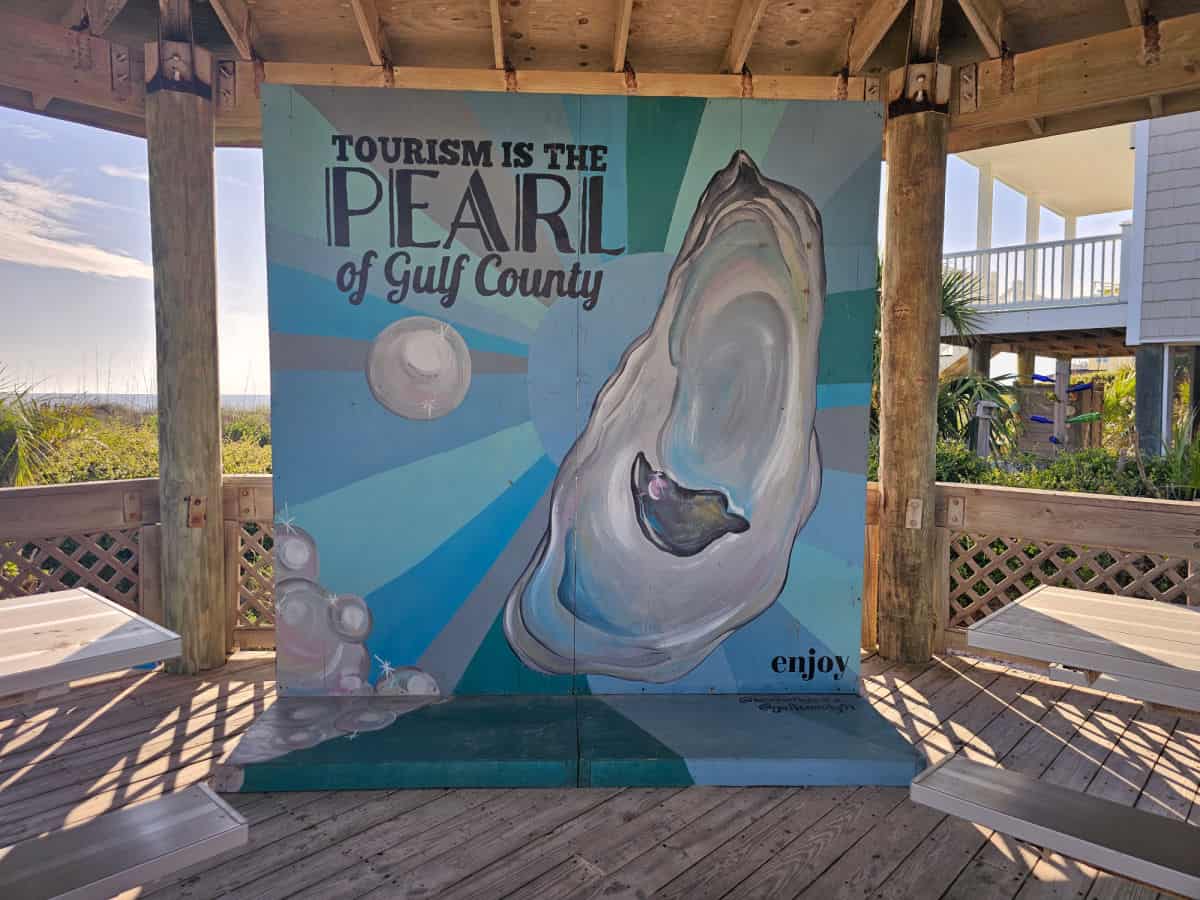 Tourism is the pearl of Gulf County sign with a pearl mural