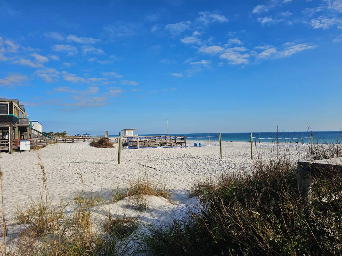 Looking over the sand to beach volleyball nets and the Gulf of Mexico by the Okaloosa Boardwalk