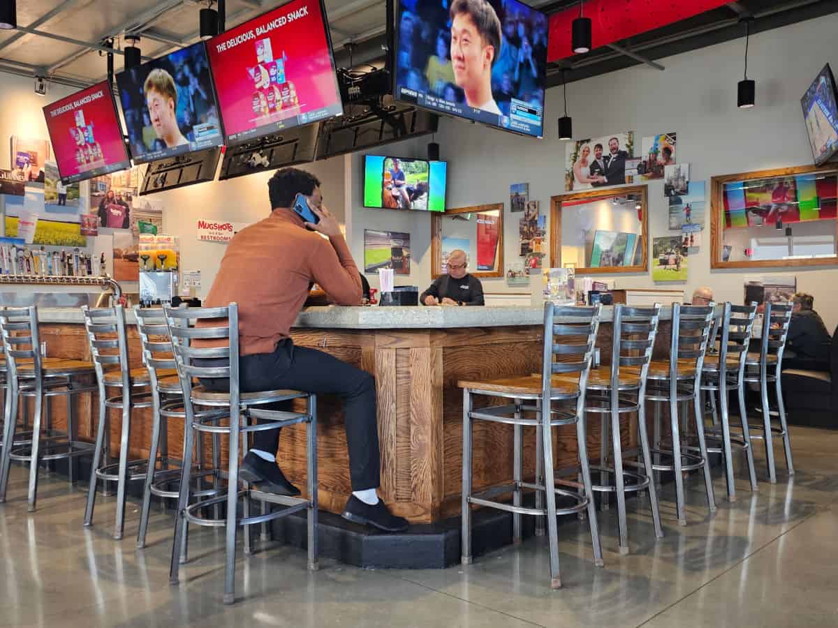 Mugshots bar wtih tall chairs and lots of TVs around the bar