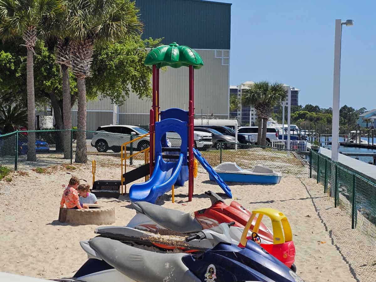 kids play area with toys and play equipment in the sand