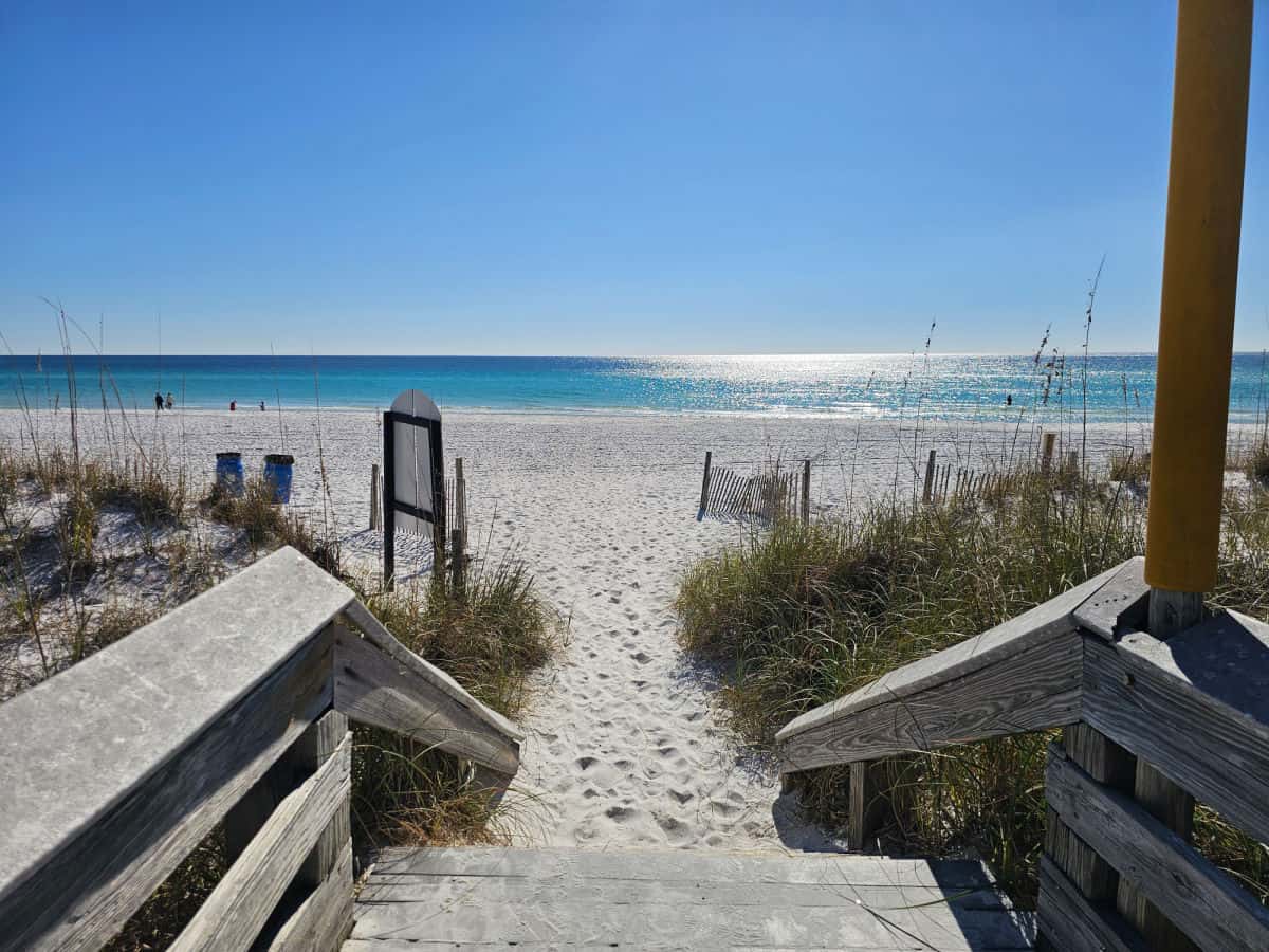 Steps leading down to white sand beach with Gulf