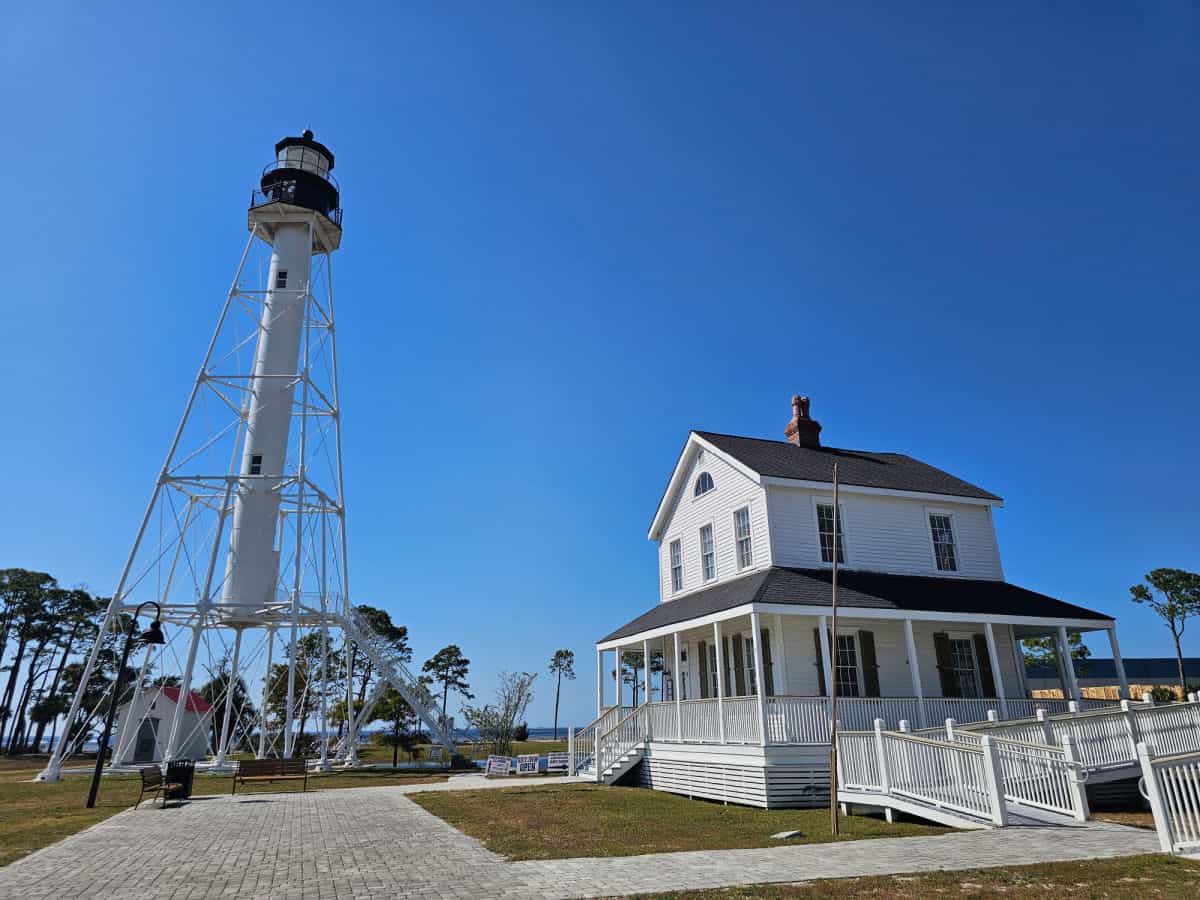 Cape San Blas lighthouse next to the keepers house on a blue sky day