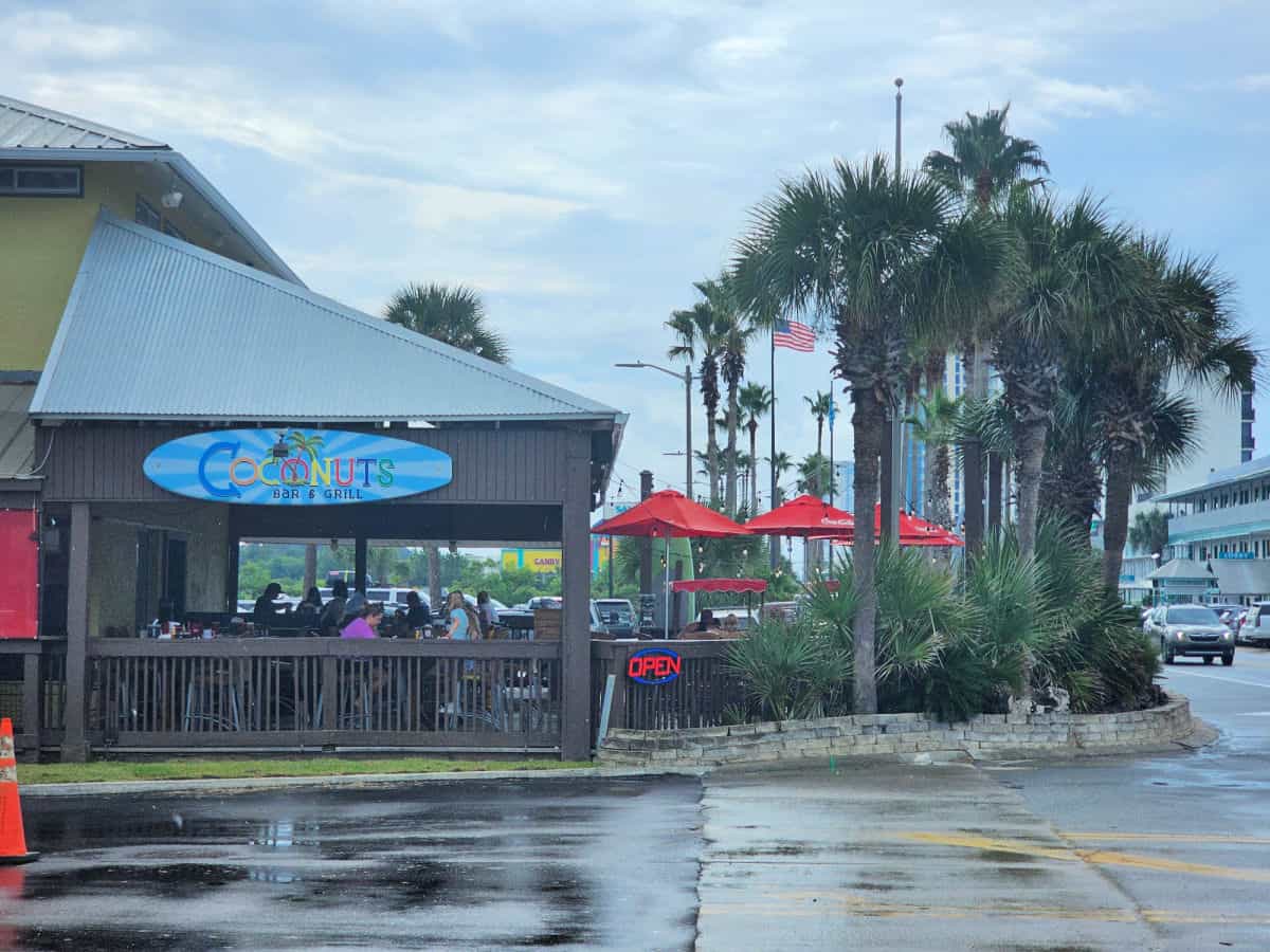 Coconuts Bar & Grill sign over outdoor seating