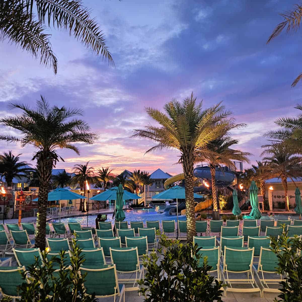 gorgeous sunset over the pool and palm trees at Margaritaville Beach Cottage Resort Panama City Beach