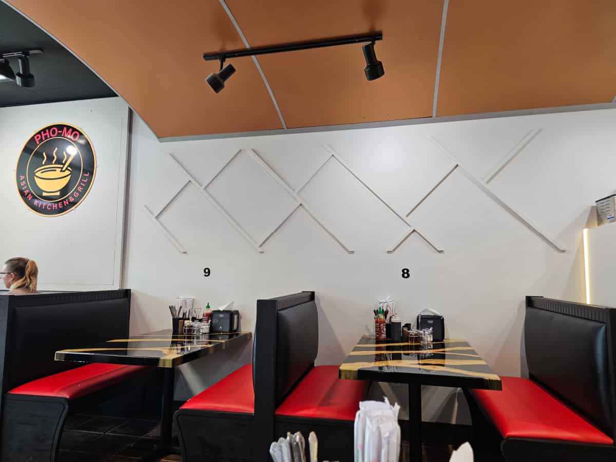 indoor seating at pho mo with red and black leather booth benches and table