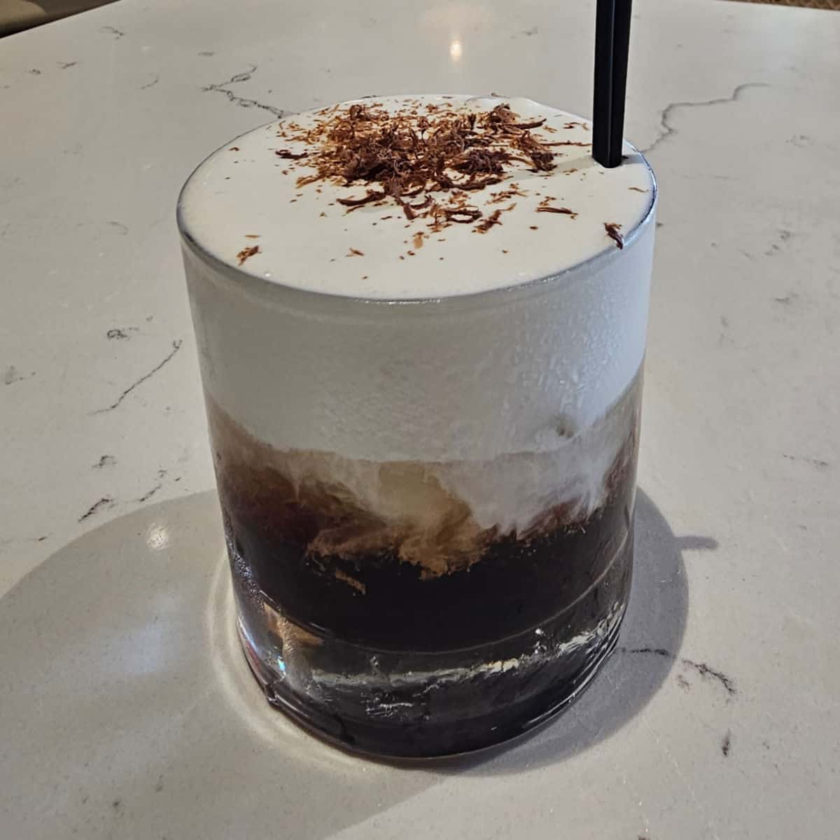 Bushwacker White Russian cocktail in a glass with chocolate shavings as garnish, Tee off at The Wharf, Orange Beach