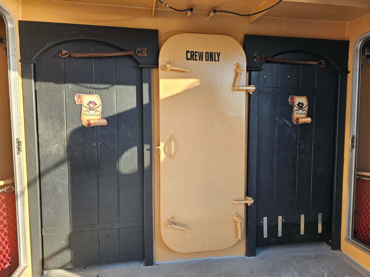 entrance doors to restrooms with wenches and pirates on the sign