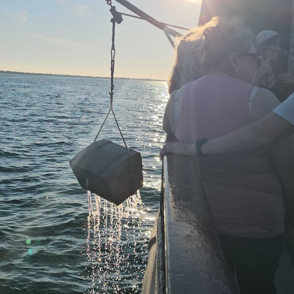 Treasure chest being lifted out of the water on the side of the buccaneer pirate ship