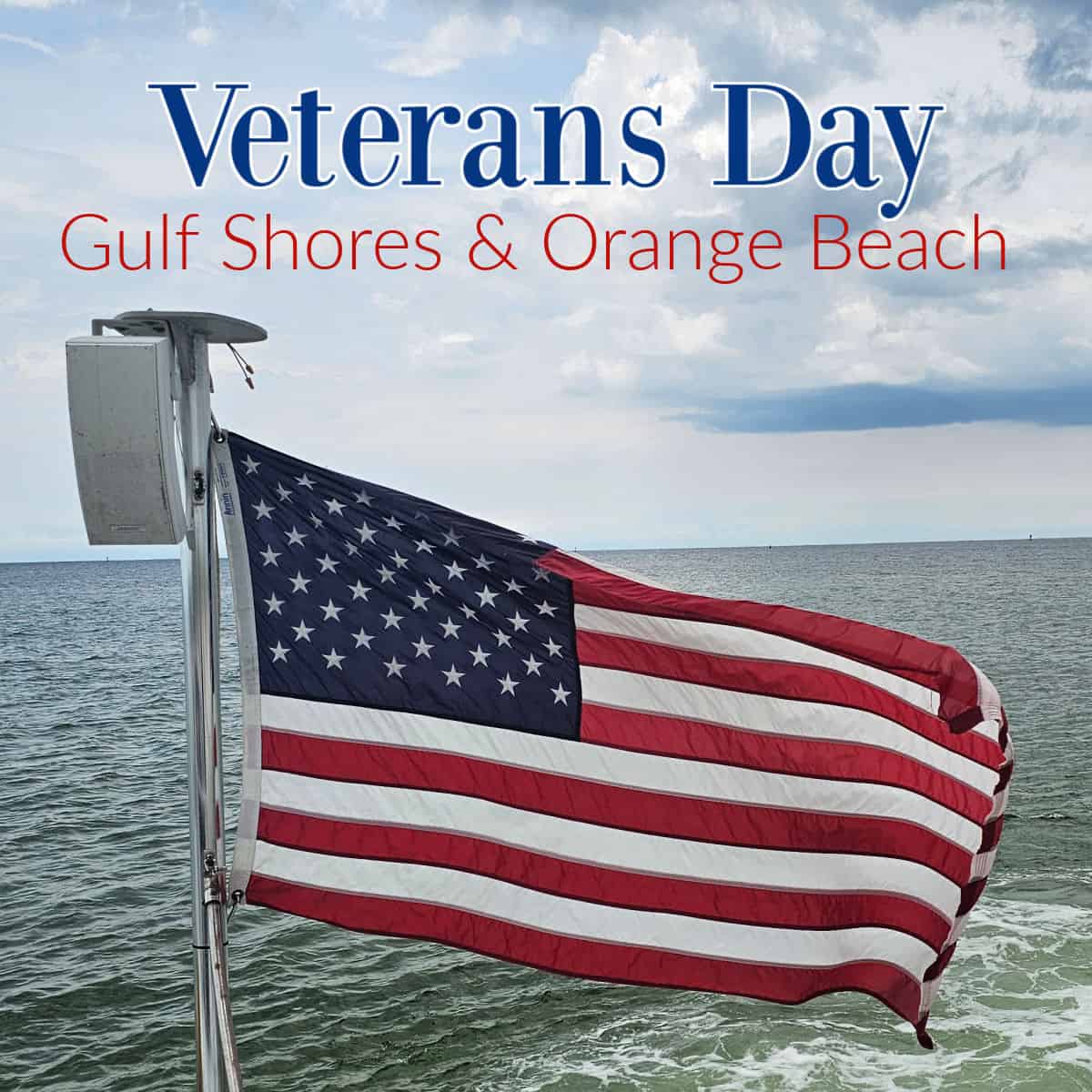 Veterans day Gulf Shores & Orange Beach over a flag with the Gulf in the background on a cloudy day