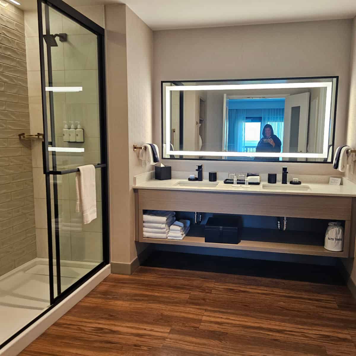 king suite bathroom with a lighted mirror, and walk in shower