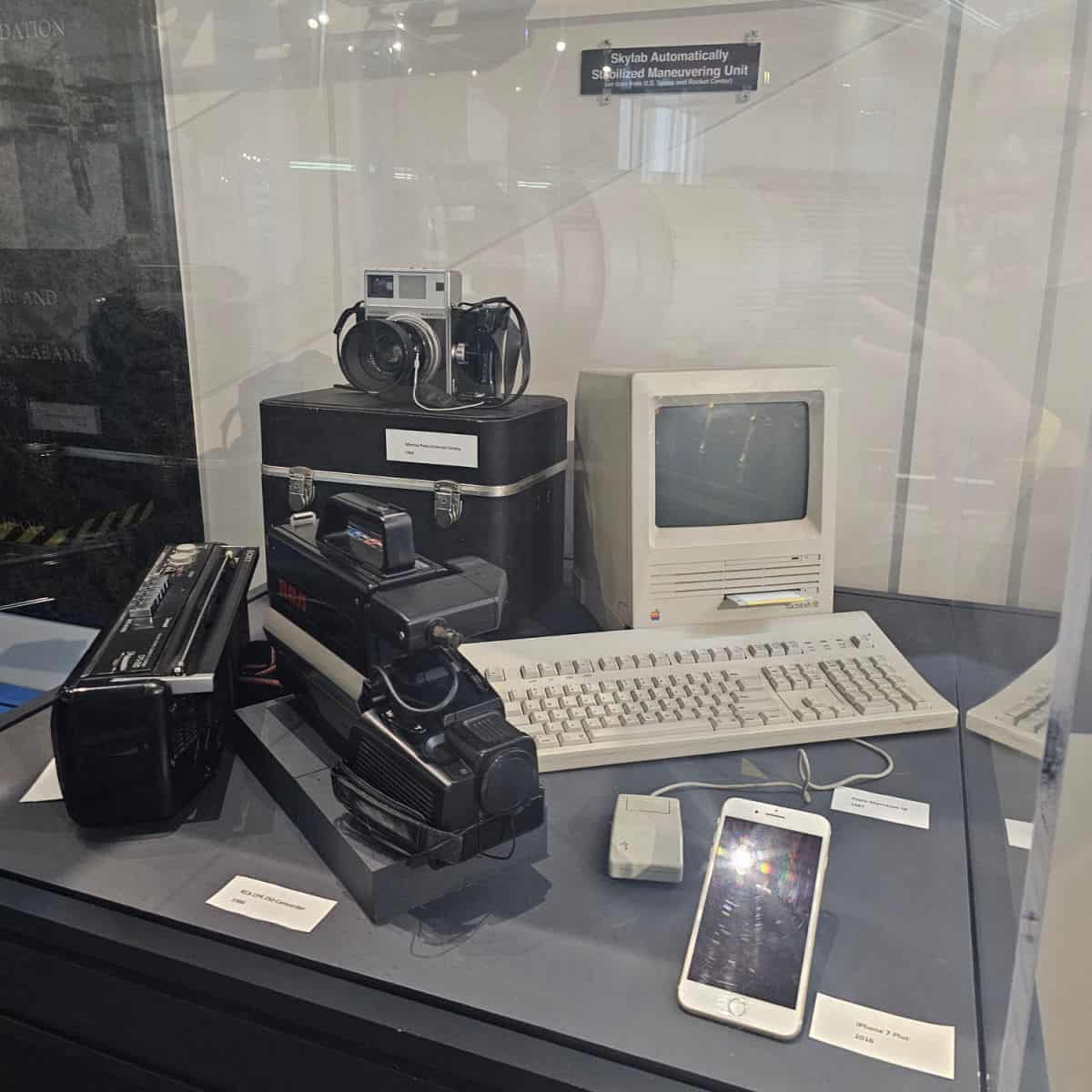 old computers and cameras in a display