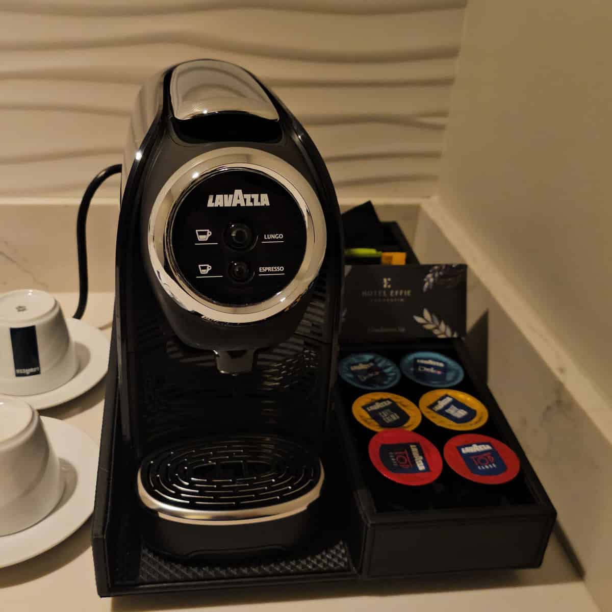 lavazza coffee maker with pods and two glasses