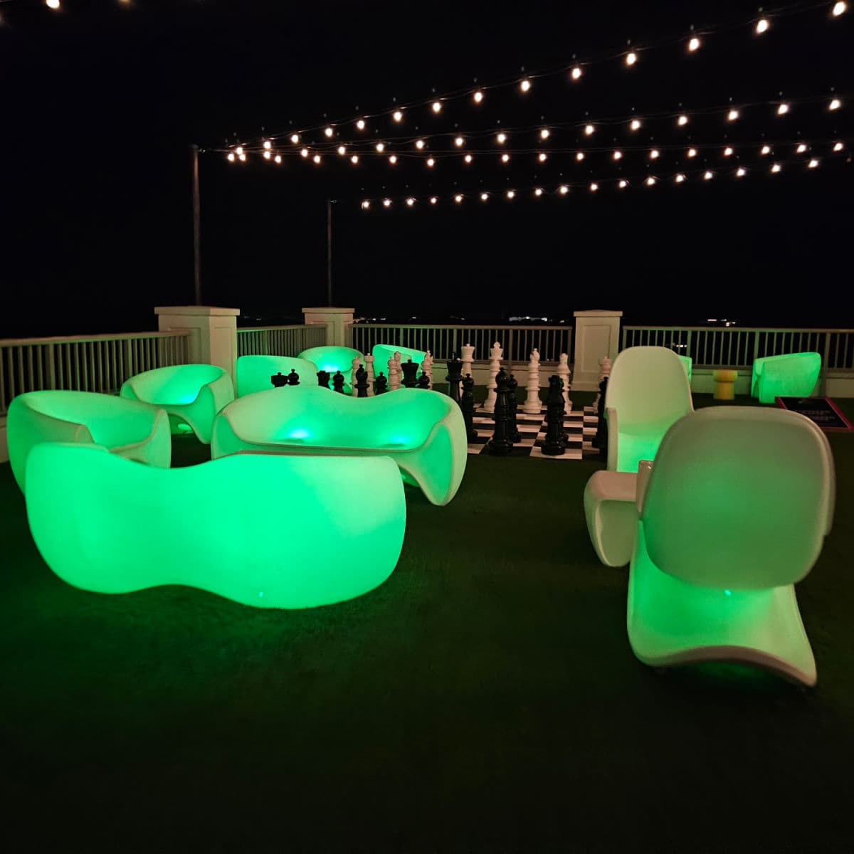 glowing plastic chairs and chess set on the rooftop pool deck hotel effie