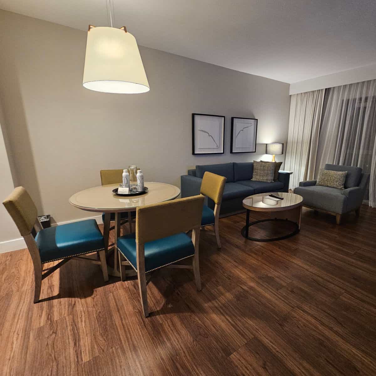 Seating area with table and chairs, couch and table in a king suite at the Hotel Effie