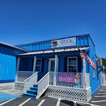 Spoonz Hand Rolled Ice Cream sign on a birght blue building