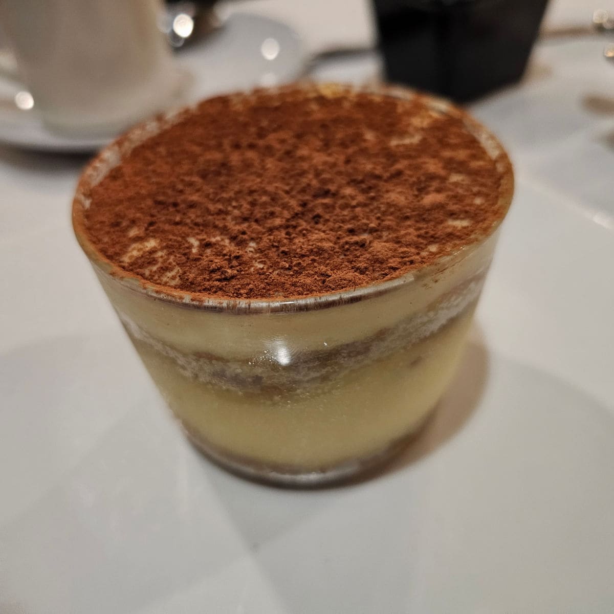 Tiramisu in a cup topped with chocolate powder