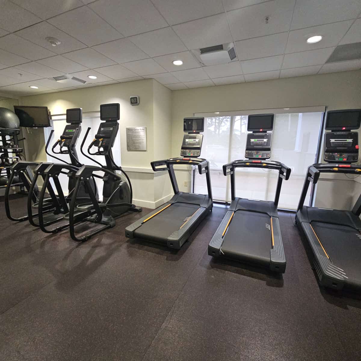 Fitness center with three treadmills, eliptical and weights in the corner at the Courtyard Sandestin