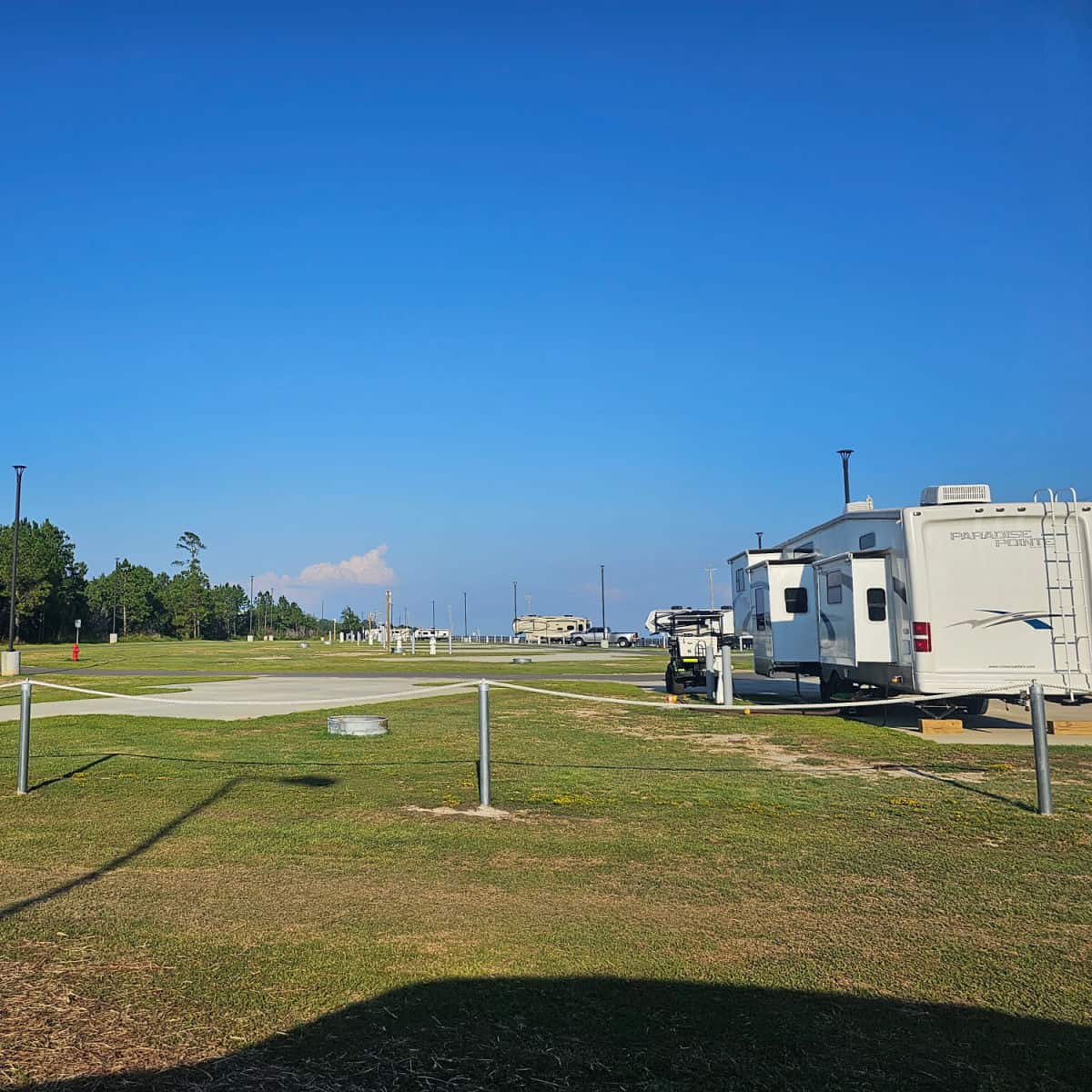 RVs in an open campground on a blue sky day, Buccaneer State Park