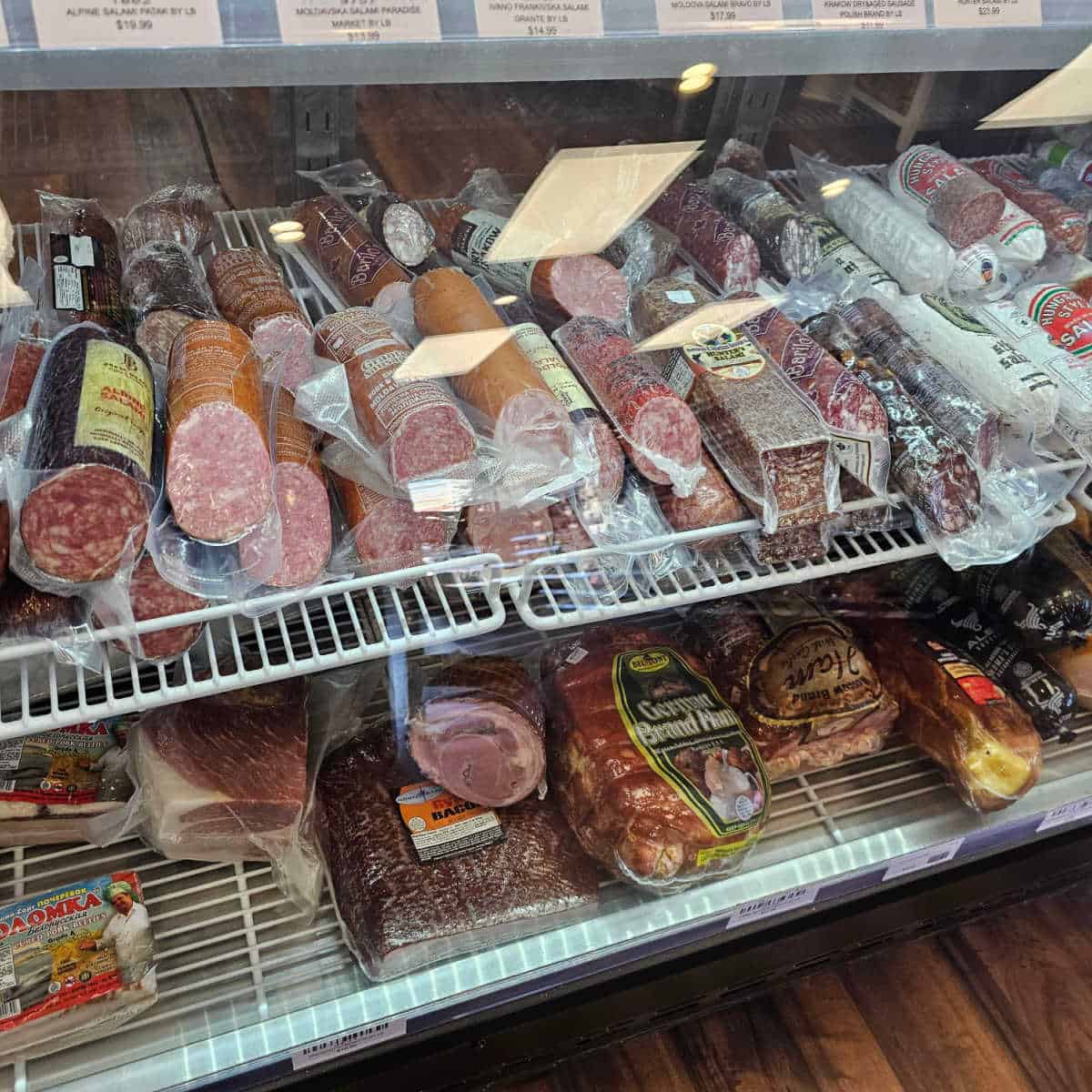 meats wrapped in a refrigerator case