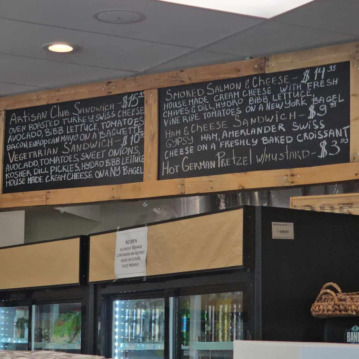 Chalkboard menu hanging from the ceiling with sandwiches