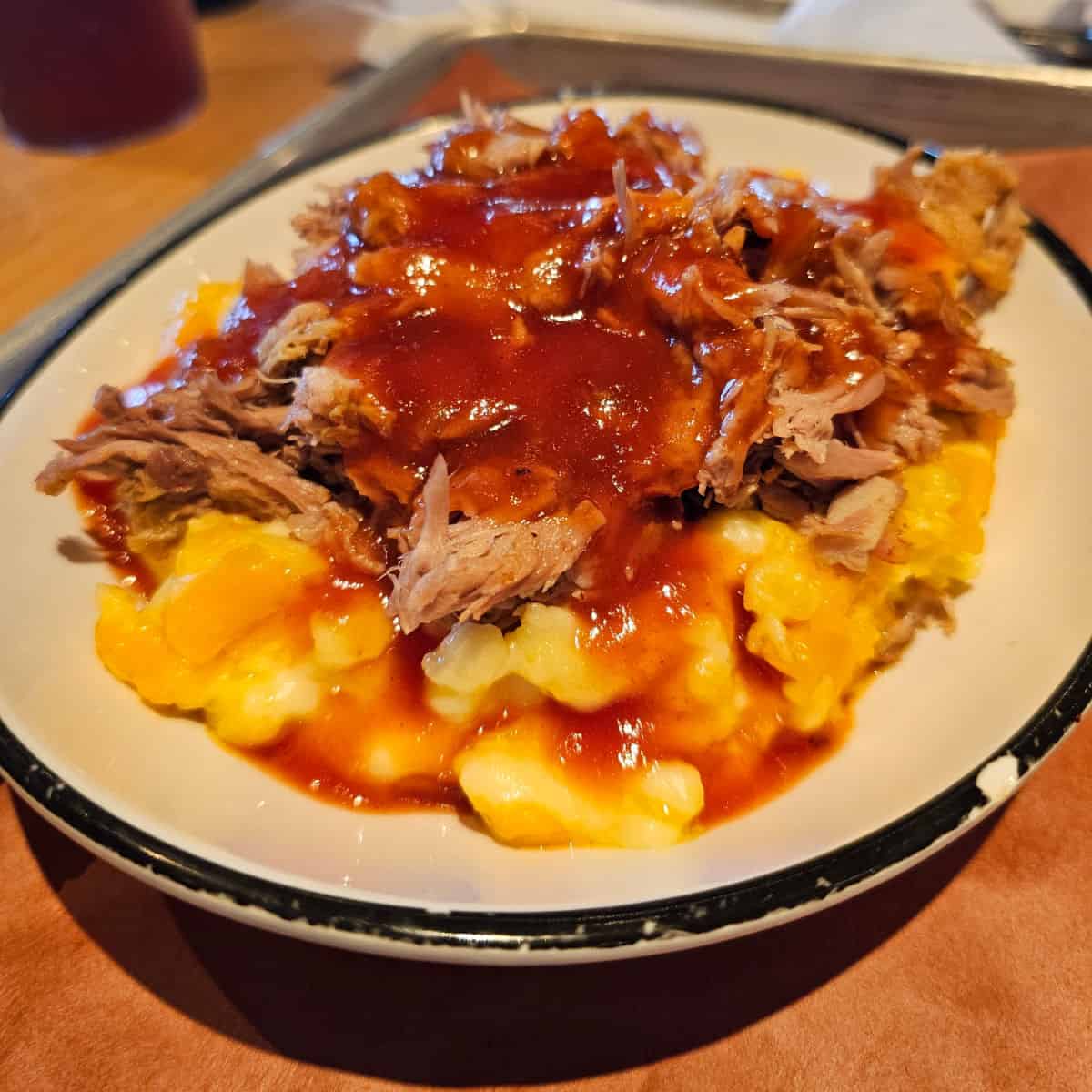Loaded Mac & Cheese in a white bowl on a tray at Jim n Nicks