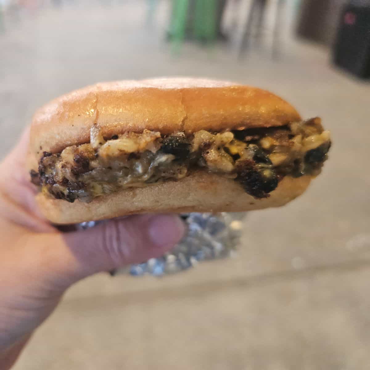 Hand holding a veggie burger