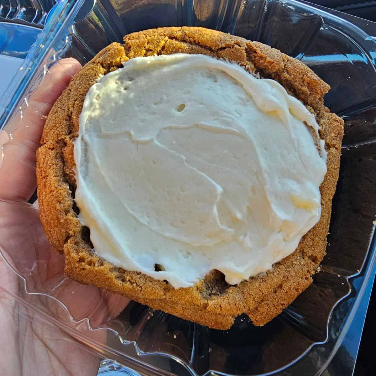 iced cinnamon roll cookie in a container