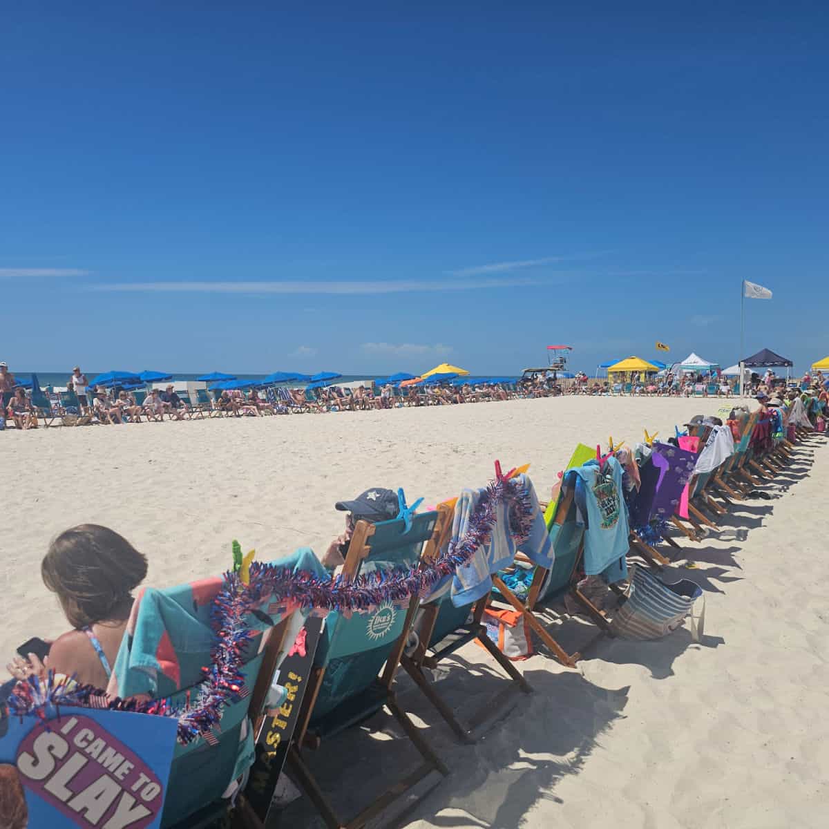 chairs in a rectangle lining the beach on a sunny day at the Flora Bama for the Mullet Toss
