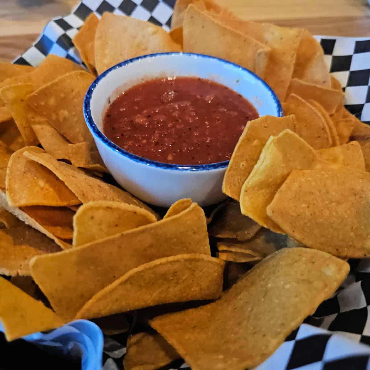 chips and salsa in a checkered paper lined dish