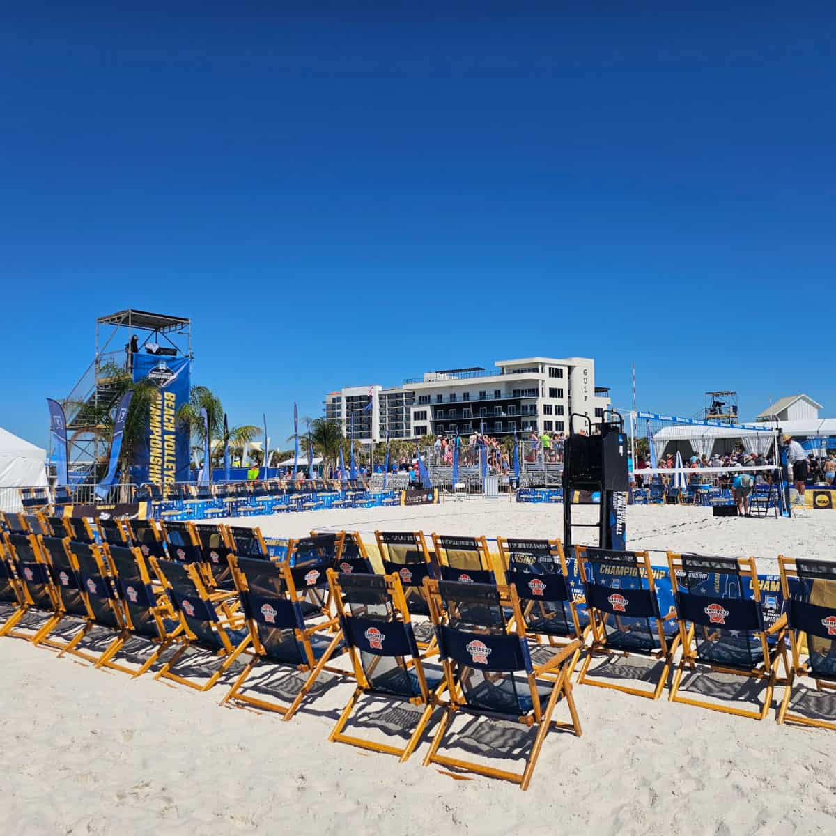 beach volleyball set up wtih beach chairs in the sand, Camera stand with Beach Volleyball Championship banner down it