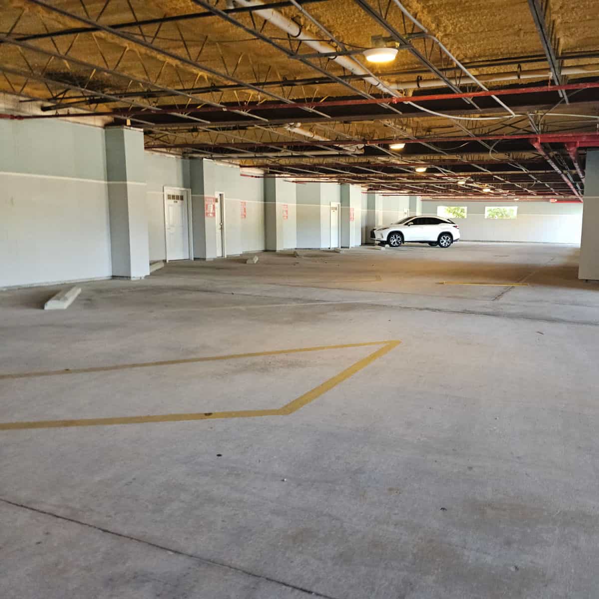 underground parking with storage next to the parking spaces