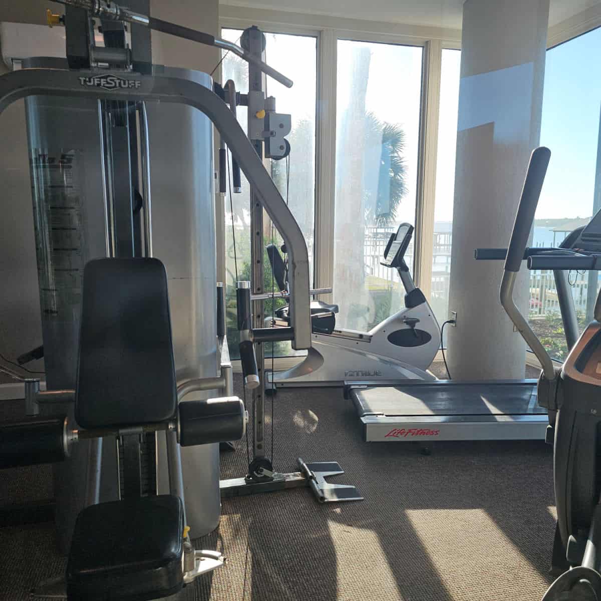 Fitness room with bike, treadmill, eliptical, and weight machine at Lagoon Tower