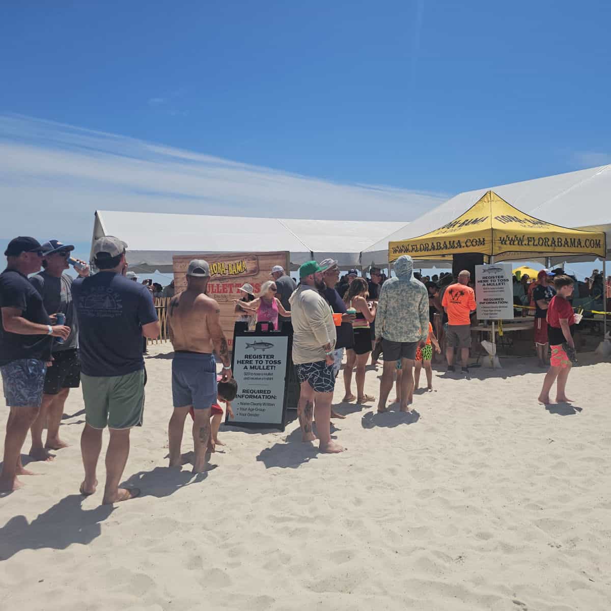 line on the sand to the flora bama tent with registration for the mullet toss