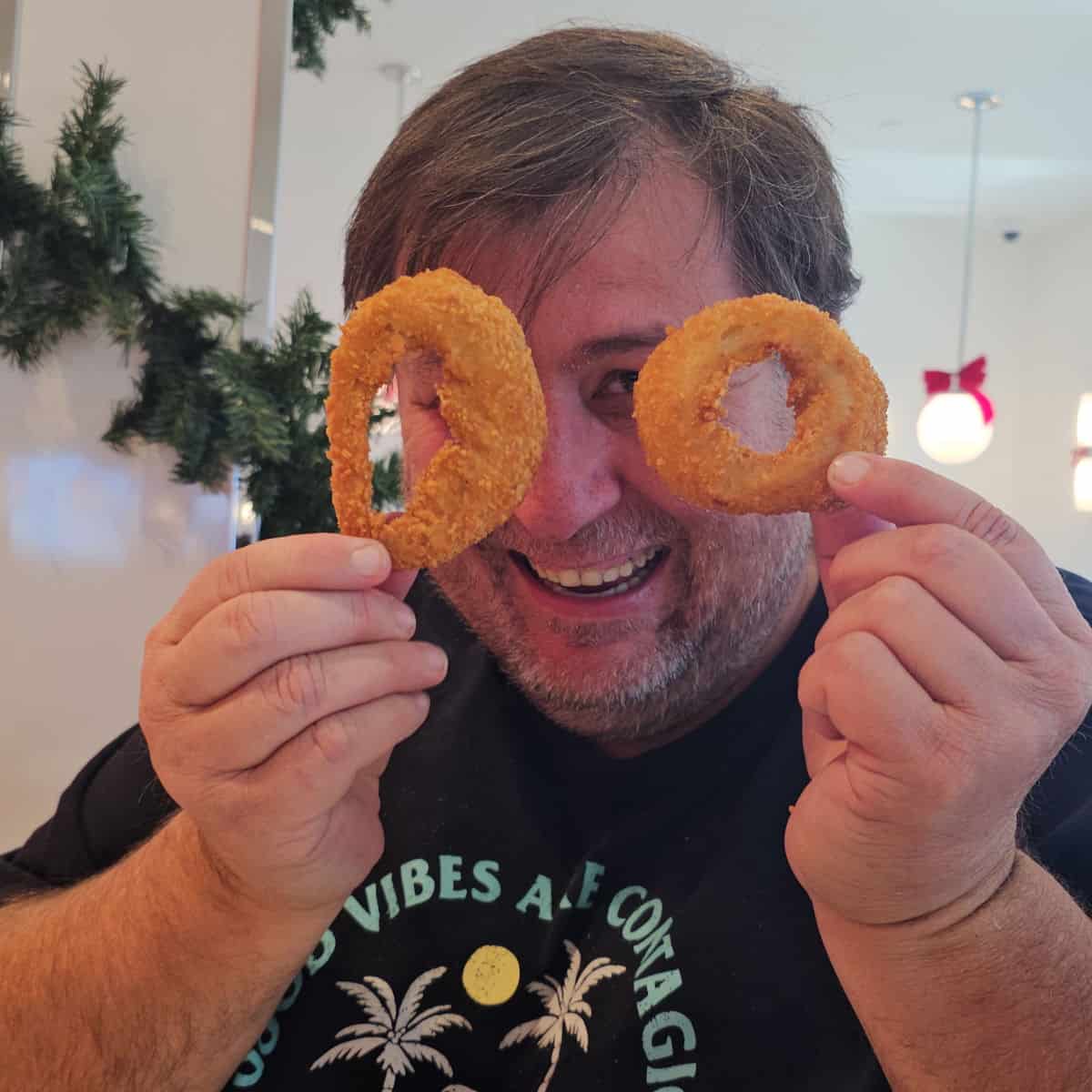 John holding onion rings up to make glasses