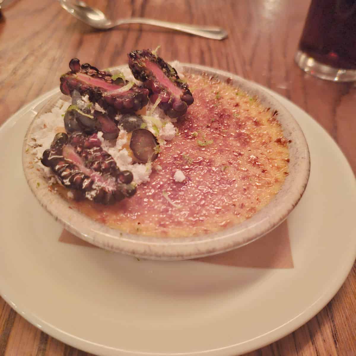 mango creme brule in a white dish on a plate