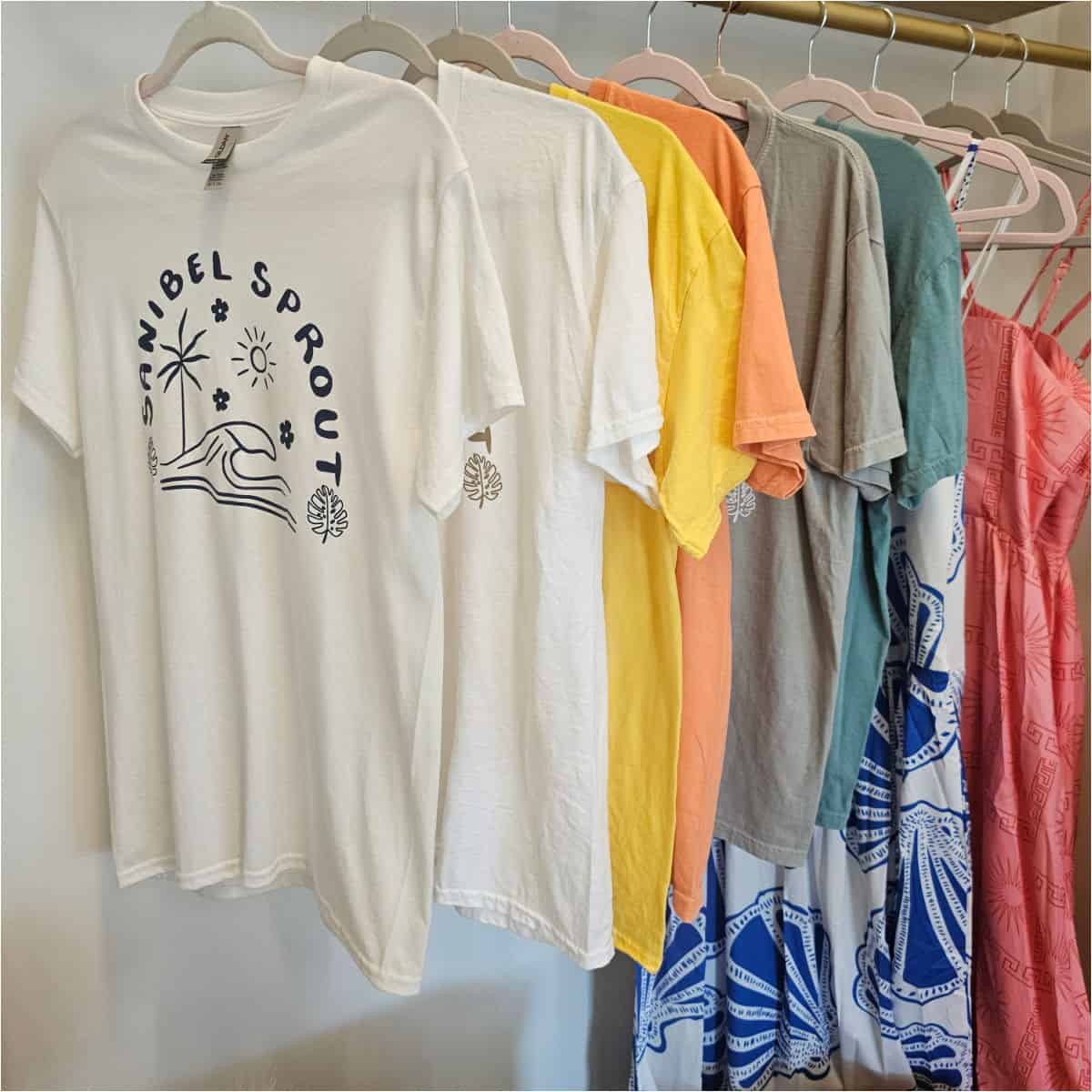 Sanibel sprout shirts hanging on a bar