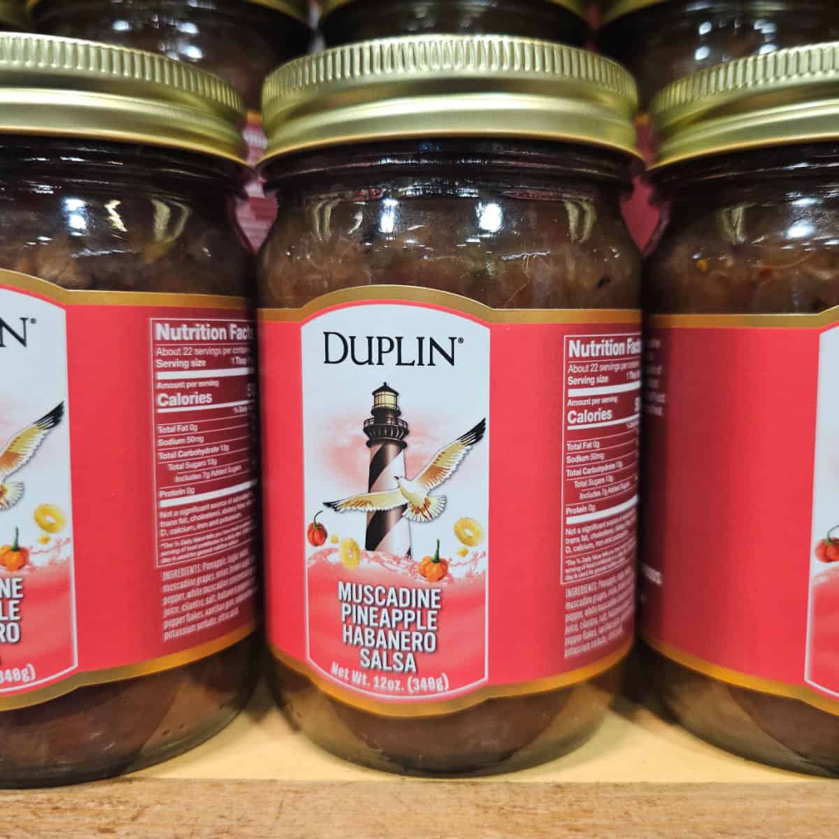Containers of Duplin Muscadine Pineapple Habanero Salsa on a shelf