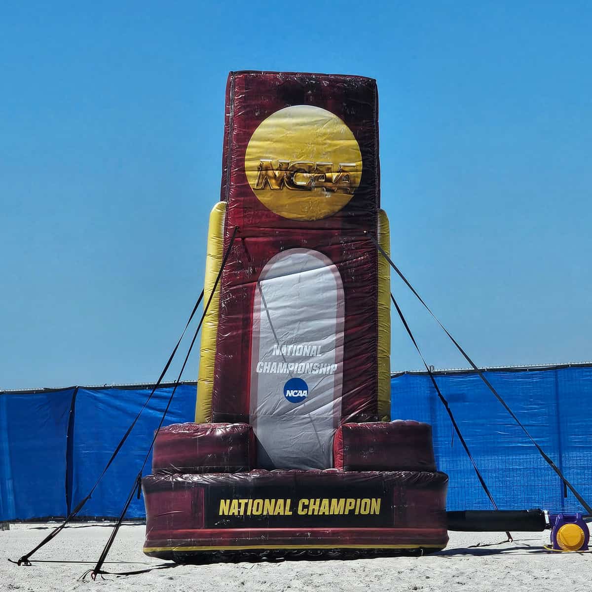 Inflatable NCAA National Championship aware by a blue fence