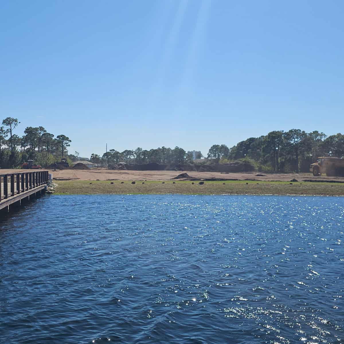looking across the water to a dump truck moving dirt for the new vineyard at Duplin Winery PCB